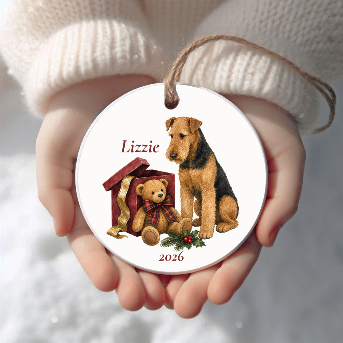 Personalized Airedale Terrier (Sitting) Bear Necessities Christmas ornament held in cupped hands
