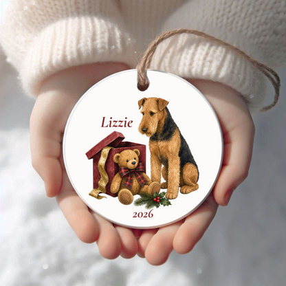 Personalized Airedale Terrier (Sitting) Bear Necessities Christmas ornament held in cupped hands