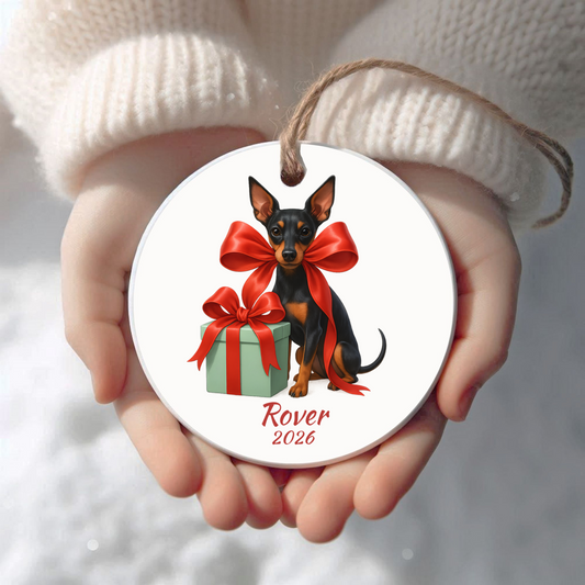 Personalized Manchester Terrier Christmas ornament held in cupped hands
