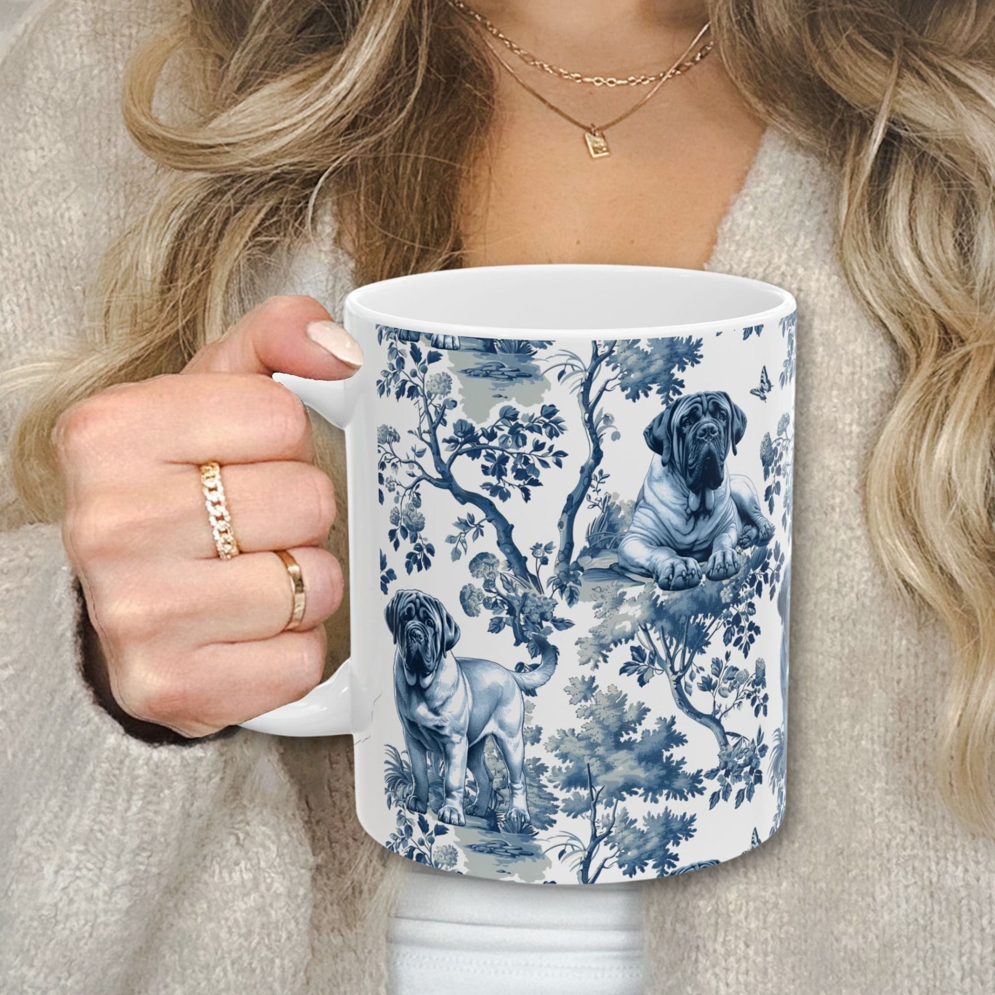 Blue toile English Mastiff coffee cup against a cozy beige sweater