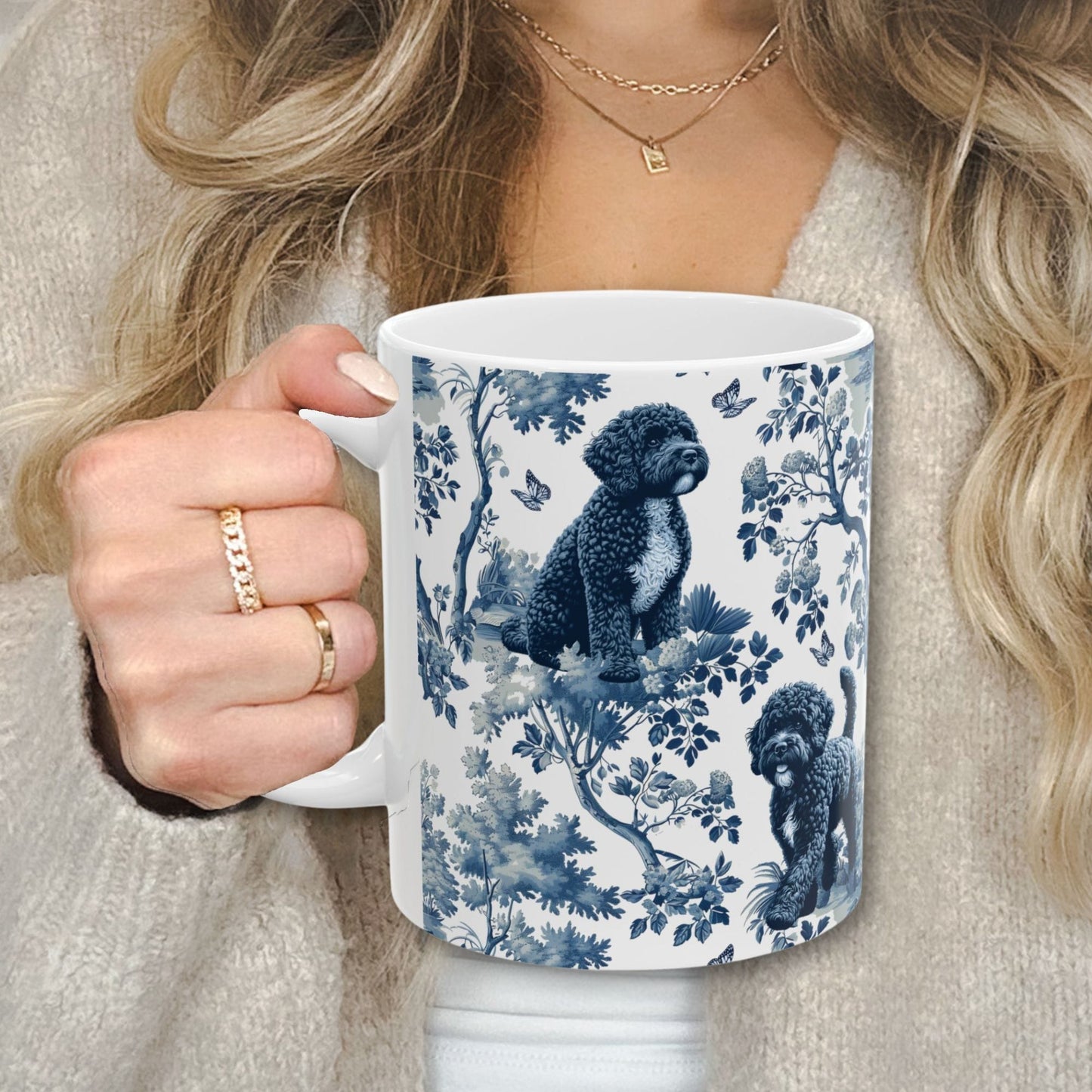 Blue toile Portuguese Water Dog coffee cup against a cozy beige sweater