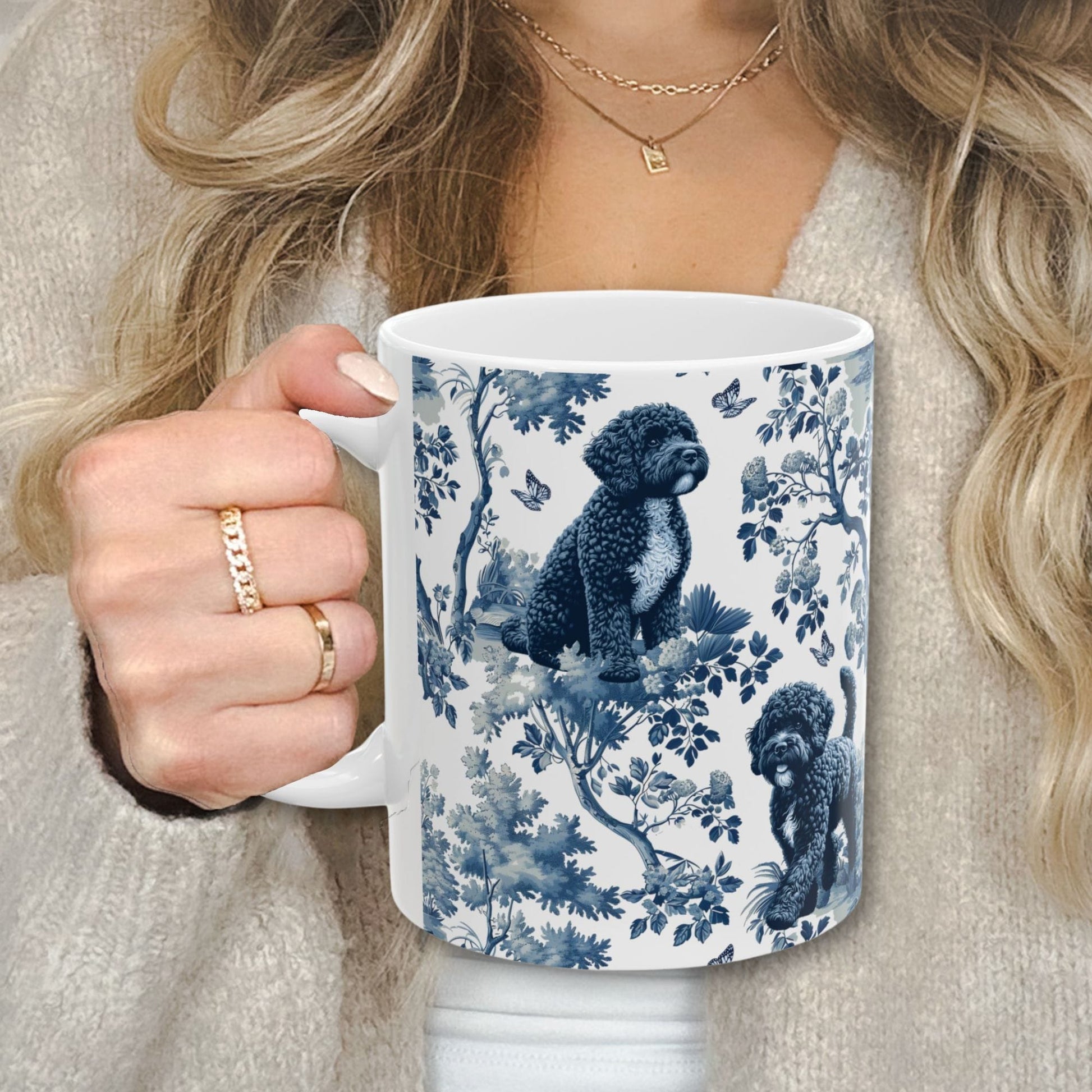 Blue toile Portuguese Water Dog coffee cup against a cozy beige sweater